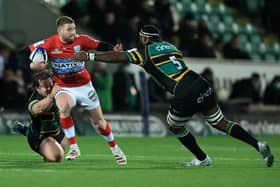 Finn Russell of Racing 92 is tackled by Api Ratuniyarawa (R) and Nick Auterac during the Heineken Champions Cup win over Northampton Saints. (Photo by David Rogers/Getty Images)