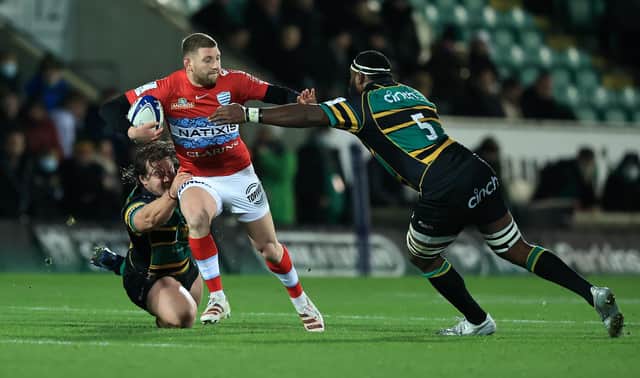 Finn Russell of Racing 92 is tackled by Api Ratuniyarawa (R) and Nick Auterac during the Heineken Champions Cup win over Northampton Saints. (Photo by David Rogers/Getty Images)