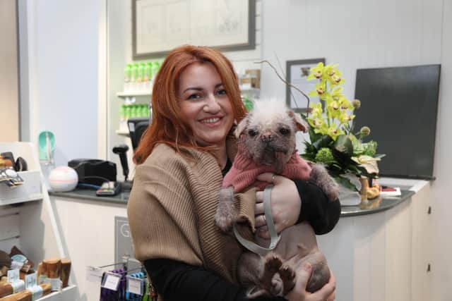 The winner of the UK's ugliest dog competition claimed her prize pamper session at a luxury doggie spa yesterday accompanied by her mum Holly.