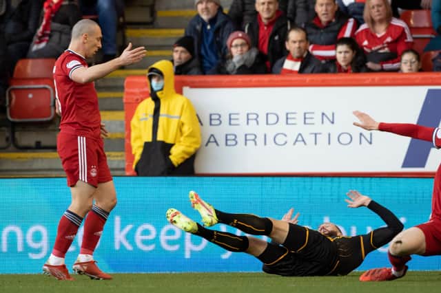 Aberdeen's Scott Brown (left) and Motherwell's Kevin van Veen clash at Pittodrie.