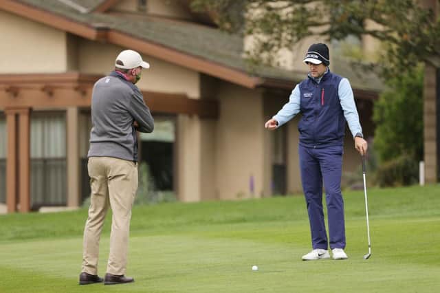 Russell Knox talks to a rules official on the first hole during the final round of the AT&T Pebble Beach Pro-Am at Pebble Beach Golf Links in California. Picture: Ezra Shaw/Getty Images.