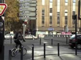 A French sign permitting cyclists to turn right on red after giving way to other traffic and pedestrians. There are similar signs for going straight ahead at some junctions