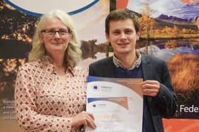 Chair of the Cairngorms Tourism Partnership, Xander McDade receives the award in Brussels