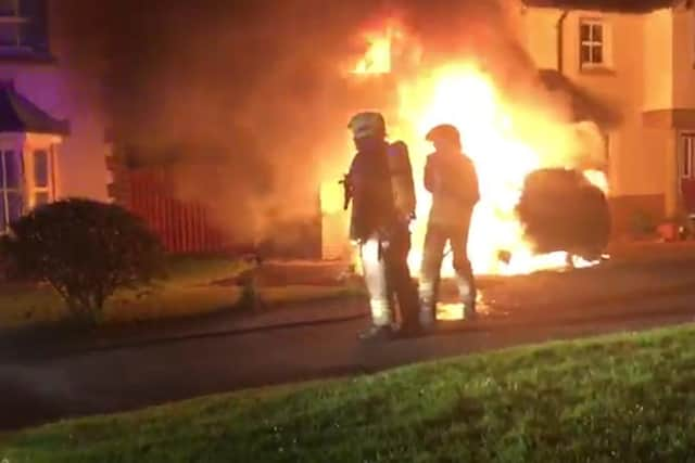 Firefighters tackle one of the blazes at Councillor Campbell's home.