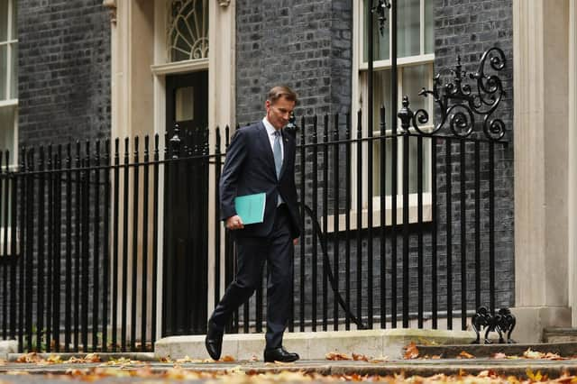 Jeremy Hunt leaves Downing Street to present his autumn statement to the House of Commons (Picture: Dan Kitwood/Getty Images)