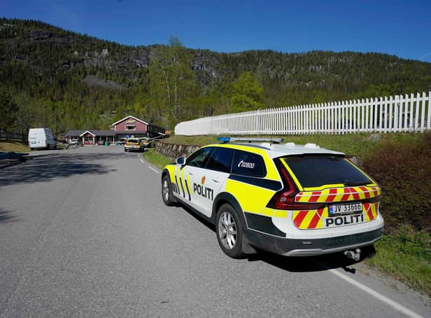 A police car stands near the crime scene where three people have been stabbed  in the village of Nore in Numedal, Norway, on May 20, 2022. - At least three people were injured, including one seriously, in southeastern Norway in a stabbing attack, Norwegian police said.
