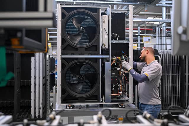 An employee works on air-to-water heat pumps in monobloc design in the production line at the headquarters of the heating technology company Vaillant Group in Remscheid, Germany.