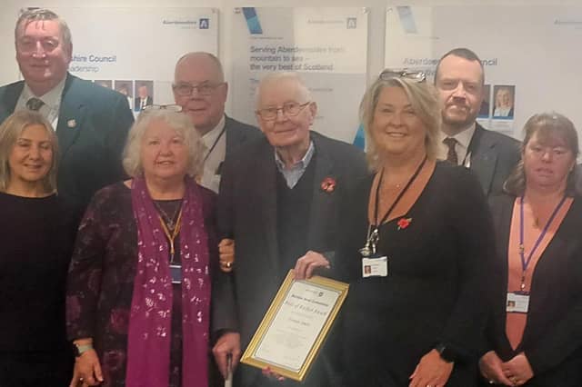 Norman was presented with his Pride of Buchan award by current Buchan Area Committee chair Cllr Dianne Beagrie watched by local councillors and members of Longside Community Council.