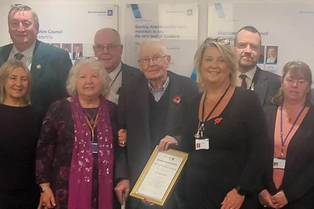 Norman was presented with his Pride of Buchan award by current Buchan Area Committee chair Cllr Dianne Beagrie watched by local councillors and members of Longside Community Council.