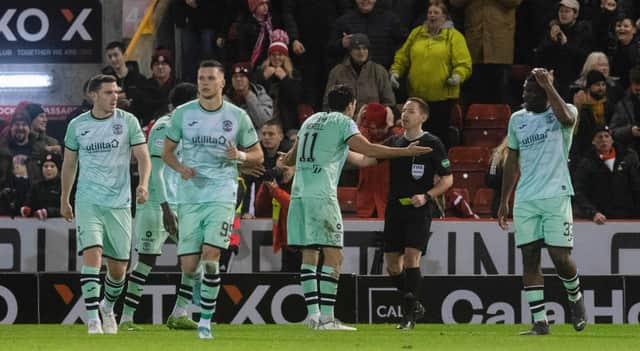 Hibs players complain to referee David Munro about the penalty decision the led to Aberdeen's opener. (Photo by Craig Foy / SNS Group)