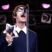 Liam Gallagher performs on stage with Oasis at Glastonbury in 1994.