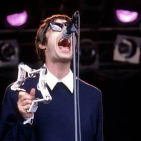Liam Gallagher performs on stage with Oasis at Glastonbury in 1994.