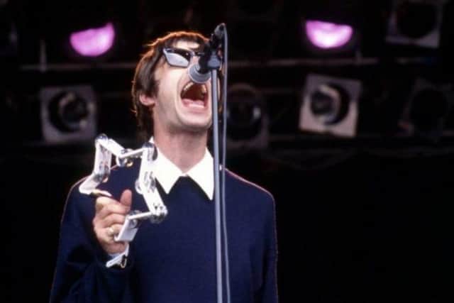 Liam Gallagher performs on stage with Oasis at Glastonbury in 1994.