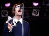 Liam Gallagher performs on stage with Oasis at Glastonbury in 1994.