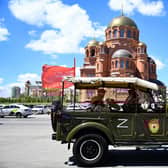 Tourists wearing World War Two-era styled outfits take a city tour in a historical military vehicle adorned with the letter Z, which has become a symbol of support for Russian military action in Ukraine, in the southern city of Volgograd. Picture: Kirill Kudyavtsev/AFP via Getty Images