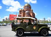 Tourists wearing World War Two-era styled outfits take a city tour in a historical military vehicle adorned with the letter Z, which has become a symbol of support for Russian military action in Ukraine, in the southern city of Volgograd. Picture: Kirill Kudyavtsev/AFP via Getty Images