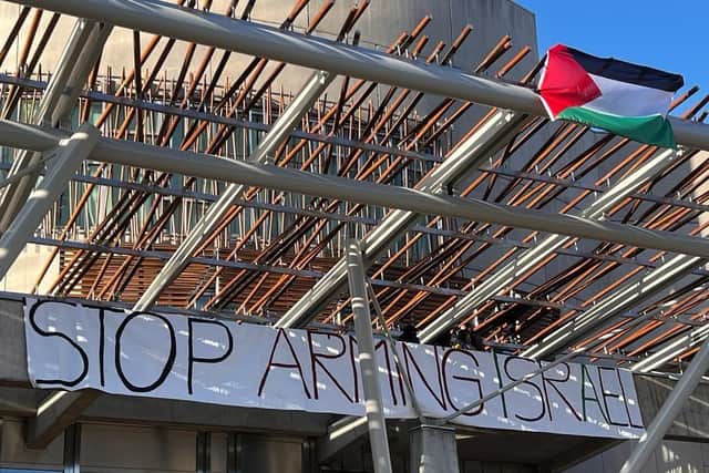 Four protesters have climbed onto the Scottish Parliament roof. Picture: Lisa Ferguson