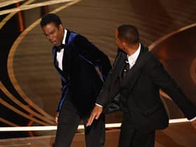 Actor Will Smith (R) slaps US actor Chris Rock onstage during the 94th Oscars at the Dolby Theatre in Hollywood, California