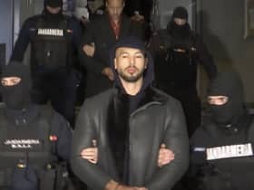 Andrew Tate is led away by police from an address in Ilfov, north of Bucharest, Romania (Picture: Observator Antena 1 via AP)