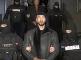 Andrew Tate is led away by police from an address in Ilfov, north of Bucharest, Romania (Picture: Observator Antena 1 via AP)