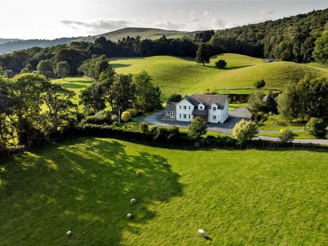 Aerial view of property and land.
