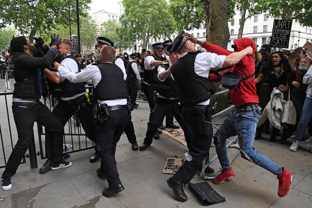 Protestors scuffle with police officers near the entrance to Downing Street during an anti-racism demonstration in London (Picture: Daniel Leal-Olivas/AFP via Getty Images)