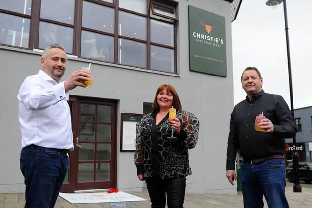 Owners David Blackwood, left, and Tom Malloy along with business partner Yvonne Latta celebrate the opening of Christies Scottish Tapas restaurant back in 2021 (Picture: Michael Gillen, National World)