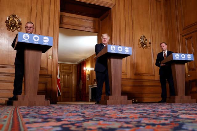 Boris Johnson, centre, seen with Professor Jonathan Van-Tam, left, and Simon Stevens, was at pains to stress that the Covid crisis is not yet over (Picture: John Sibley/PA Wire)