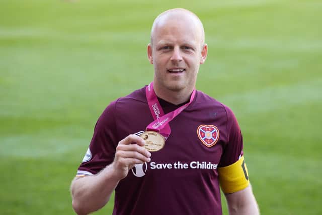 With his medal for helping Hearts return to the Premiership