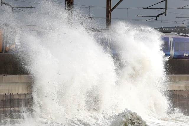 A train passes in Saltcoats on the west coast of North Ayrshire during a storm where gusts of up to 70mph hit coastal areas in Scotland. Winds of a similar strength are expected to hit the north and west coast of Scotland from this evening through to tomorrow.