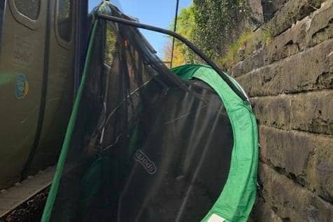 A trampoline was caught between a train and an embankment in Glasgow as Storm Aiden battered Scotland with rain and high winds. Picture: @ScotRail/Twitter/PA Wire.