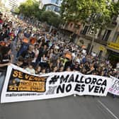 Protesters hold a banner reading 'Mallorca is not for sale' during a demonstration about housing prices and mass tourism on the island (Picture: Jaime Reina/AFP via Getty Images)