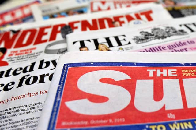 Detailed view of a pile of National newspapers including The Times, The Independent, The Sun and the Daily Mirror