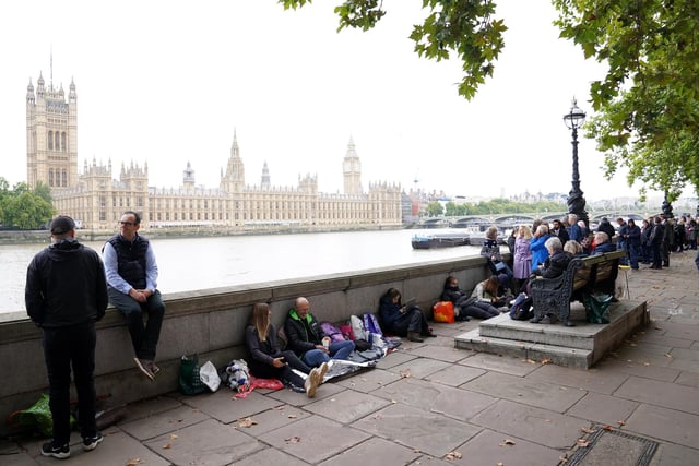 Members of the public wait in the queue near Lambeth Bridge in central London, to view Queen Elizabeth II lying in state ahead of her funeral on Monday. Picture date: Wednesday September 14, 2022.
