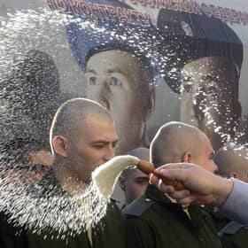 An Orthodox priest blesses Russian conscripts at a military registration and enlistment office in Saint Petersburg. Picture: Olga Maltseva/AFP/Getty