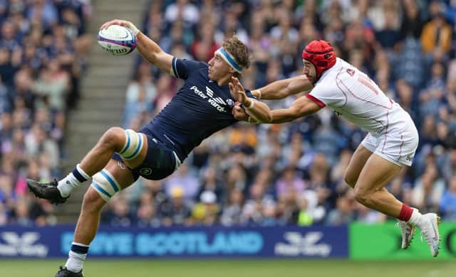 An explosive moment as Jamie Ritchie is tackled in the air by Georgia's Akaki Tabutsadze, the Scotland captain reacting angrily to the incident