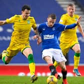 Rangers' Steven Davis and Hibs' Melker Hallberg (left) battle for possession during their league match at Ibrox. Photo by Rob Casey / SNS Group