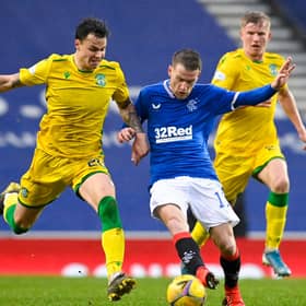 Rangers' Steven Davis and Hibs' Melker Hallberg (left) battle for possession during their league match at Ibrox. Photo by Rob Casey / SNS Group