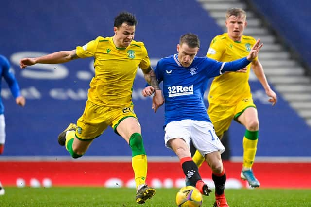 Rangers' Steven Davis and Hibs' Melker Hallberg (left) battle for possession during their league match at Ibrox. Photo by Rob Casey / SNS Group