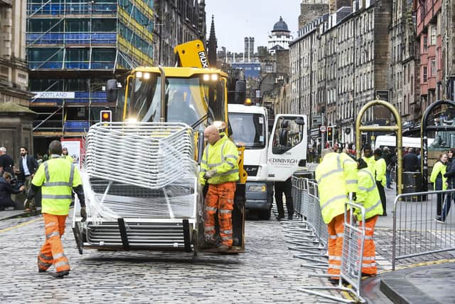 Barriers are beginning to be put on place on the Royal Mile in preparation of the Queen's body arriving in Edinburgh. Picture: Lisa Ferguson