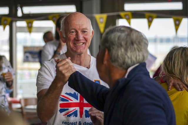 Mike McIntyre, left, the father of Olympic gold medallist Eilidh McIntyre, is congratulated at Hayling Island Sailing Club, Hampshire. Mike won gold at the Seoul Games in 1988.  Steve Parsons/PA Wire