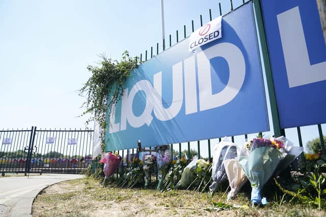 Flowers are left outside Liquid Leisure in Windsor, following the death of an 11-year-old girl. Emergency services were called at around 3.55pm on Saturday to reports of the child getting into difficulty at the water park near Datchet. Picture date: Sunday August 7, 2022.