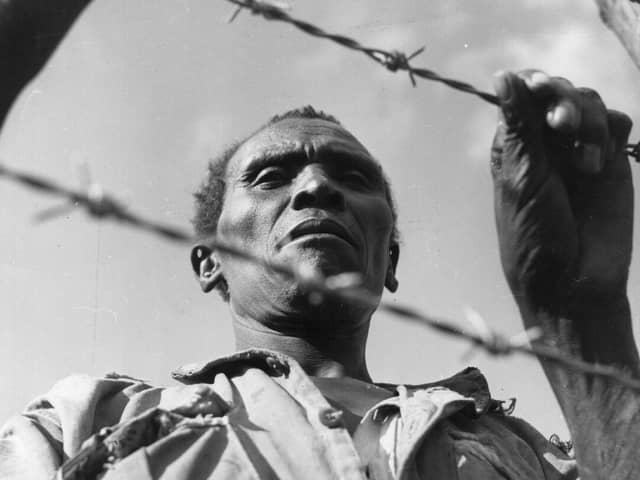A man said to be a Mau Mau soldier imprisoned in a camp in colonial Kenya in 1955 (Picture: Three Lions/Getty Images)