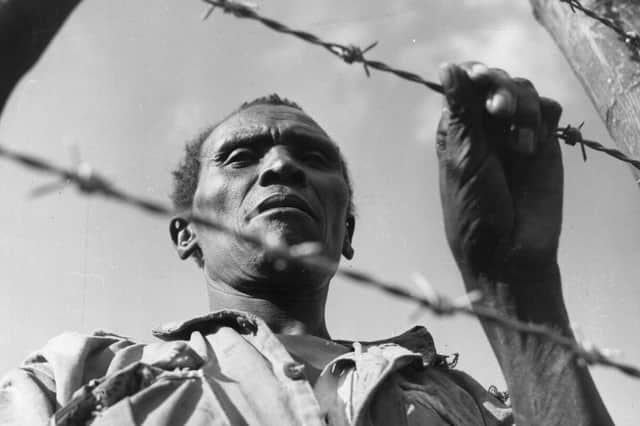 A man said to be a Mau Mau soldier imprisoned in a camp in colonial Kenya in 1955 (Picture: Three Lions/Getty Images)