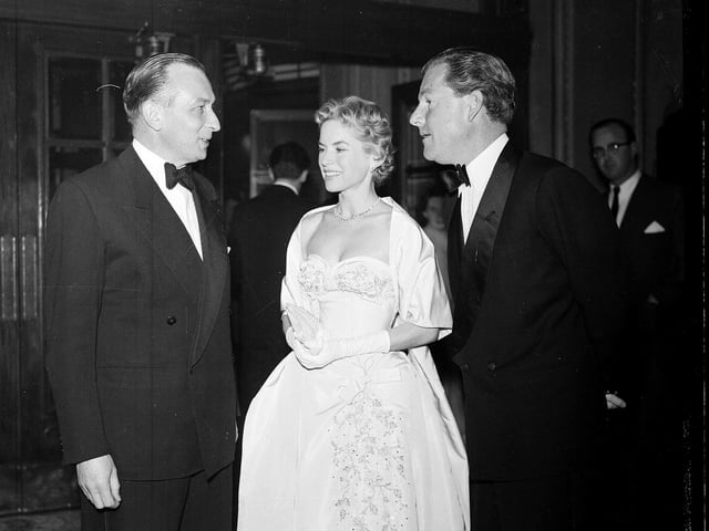Mr Forsyth Hardy, Honorary Secretary of the Edinburgh Film Festival, talks to actors Kenneth More and Muriel Pavlov at the Playhouse Cinema at a special presentation of 'Reach for the Sky' in 1956.