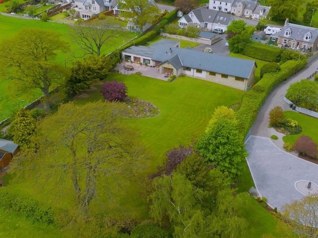 Aerial view of house and gardens.