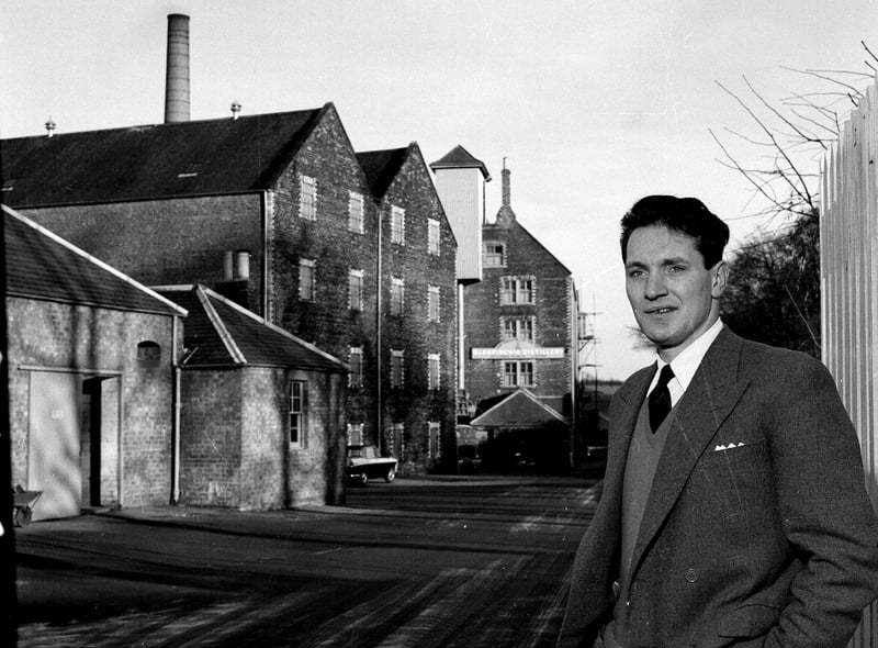 Mr W S Robertson, the manager of the Glenkinchie Whisky Distillery in East Lothian, stands in front of the distillery in December 1962.