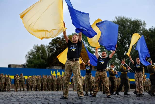 Performers attend a ceremony of raising the National Flag of Ukraine at Hetman Petro Sahaidachny National Ground Forces Academy in Lviv, Ukraine. Today marks six months since Russia launched its large-scale invasion of Ukraine. It is also the day Ukraine celebrates its 1991 independence from the Soviet Union.