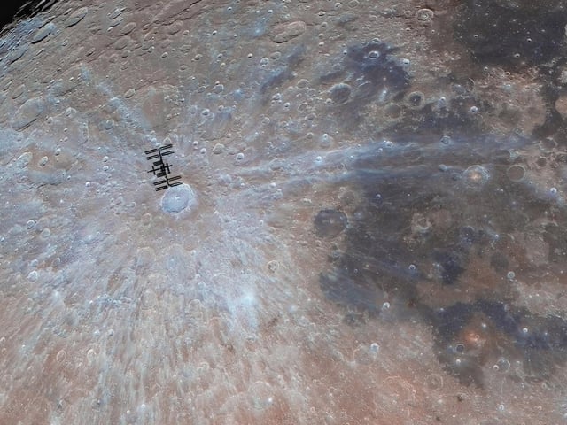 Runner-Up
A Visit to Tycho © Andrew McCarthy
In this photo, the International Space Station (ISS) has been captured in alignment with the Tycho Crater. While actually 1,000 times closer to Earth than the Moon, this perspective makes it seem like the ISS is in fact orbiting our natural satellite. McCarthy travelled to the Sonoran Desert in Arizona, USA, to find the perfect position.
‘Two cameras, two telescopes, a close eye on telemetry and a remote drive into the wilderness. To say this photographer has gone out of their way to create this spectacular image is an understatement. The ISS is often photographed as it passes over the lunar disc (from our perspective), yet few can capture it like this. The Station itself is sharp and detailed. The lunar surface below is not only thoughtfully positioned but perfectly resolved and processed. All this would make it a staggering achievement but when you also notice the brown and blue mineral colours that have been reproduced in all their subtle glory you have one of the finest ISS transit images ever made.’ - Steve Marsh
Taken with a Celestron C11 and Sky-Watcher 14" GoTo Dobsonian telescopes, Astronomik UV/IR cut filter, 2.5x Powermate lens, Hobym Traveller mount, ZWO ASI174MM and Sony A7II cameras, 4,125 mm and 2,000 mm f/10, ISO 300 and 50, 2,000 x 0.2-millisecond and 25 x 1/200-second exposures
Location: Florence, Arizona, USA