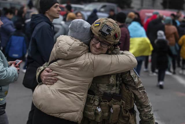 A woman hugs a Ukrainian officer as they celebrate the recapture of Kherson from Russian forces